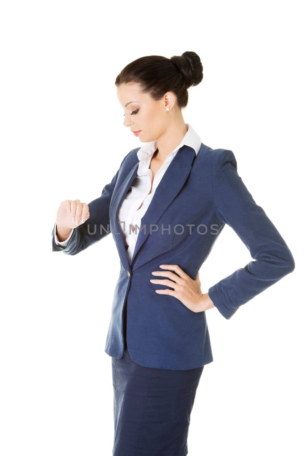 Attractive businesswoman checking time, isolated on white