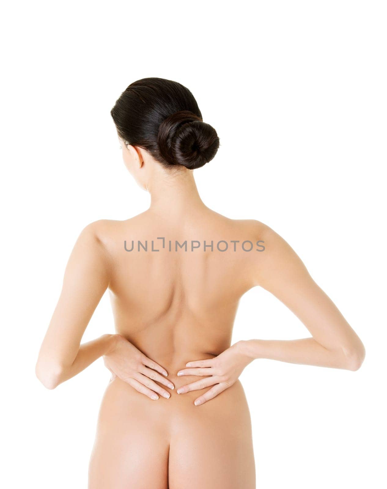 Young woman with pain in her back. Isolated on white background.