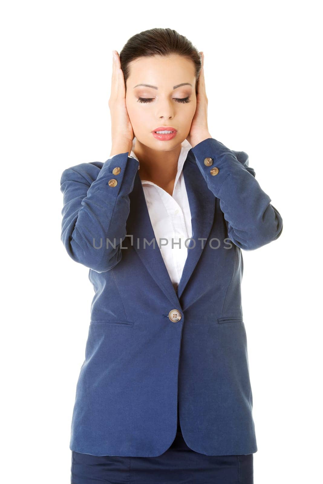 Attractive businesswoman covering her ears with hands, isolated on white