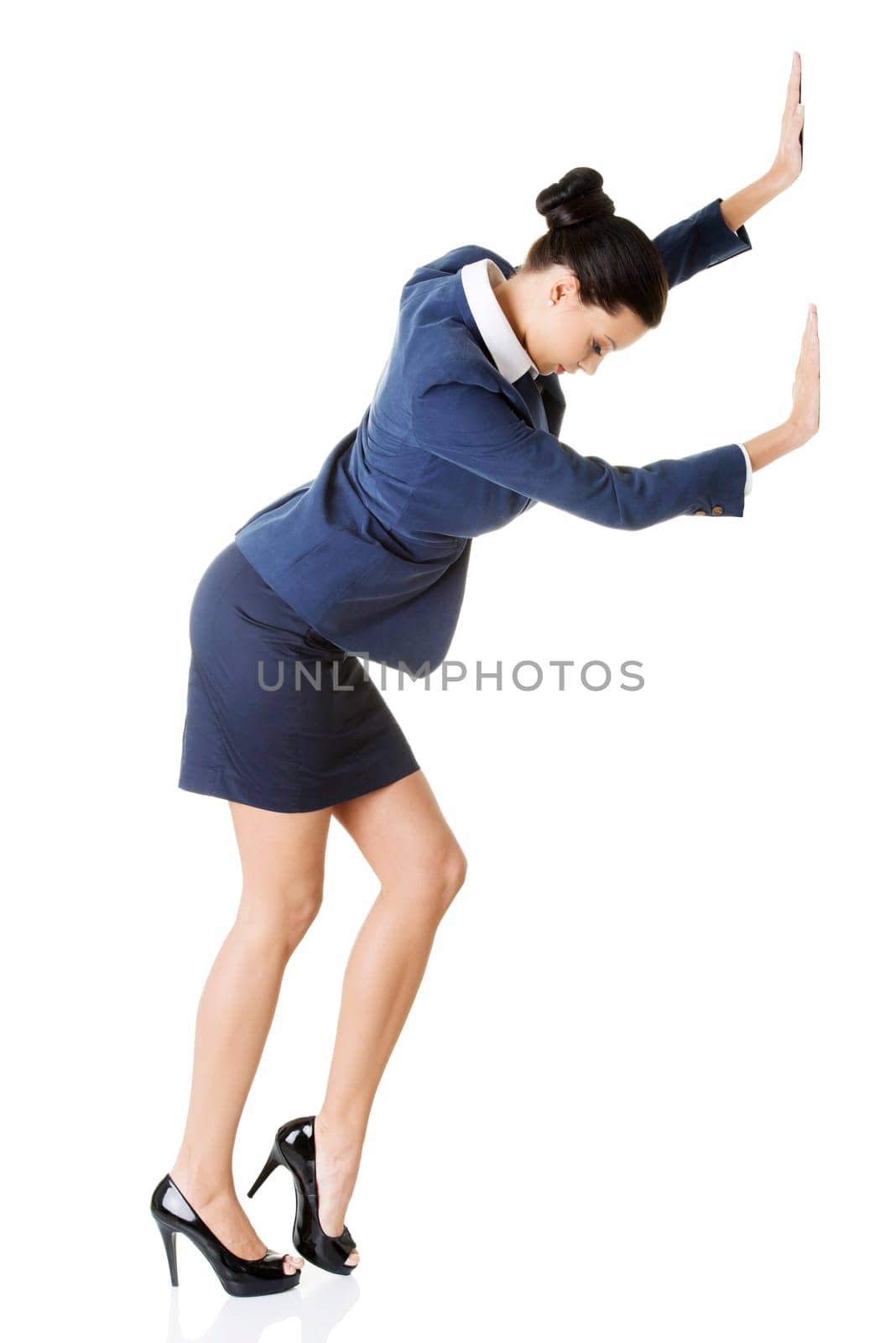 Attractive businesswoman pushing something, isolated on white