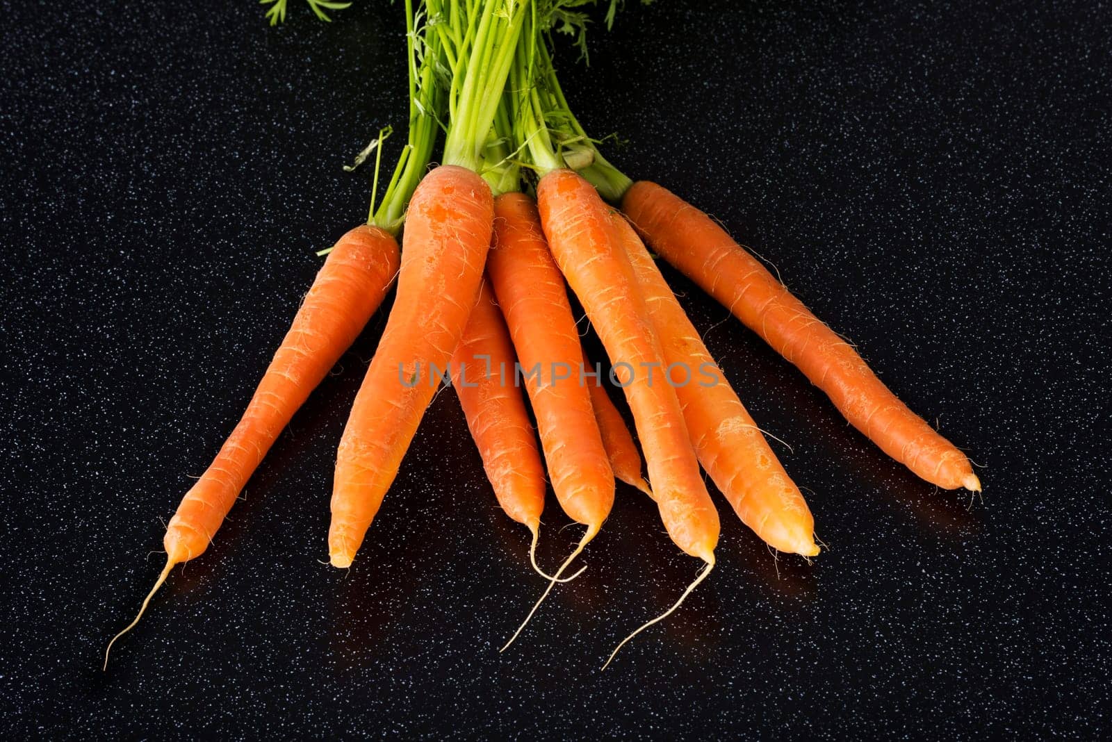 Fresh carrots bunch on table