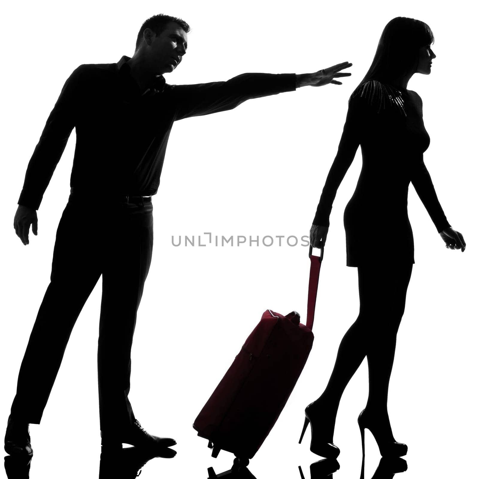 one caucasian couple dispute separation woman leaving and man holding back in studio silhouette isolated on white background