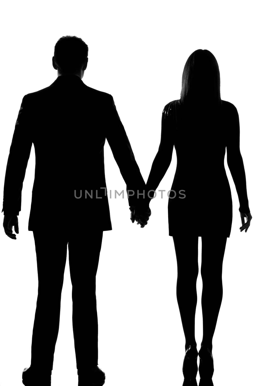 one lovers caucasian couple man and woman standing hand in hand in studio silhouette isolated on white background