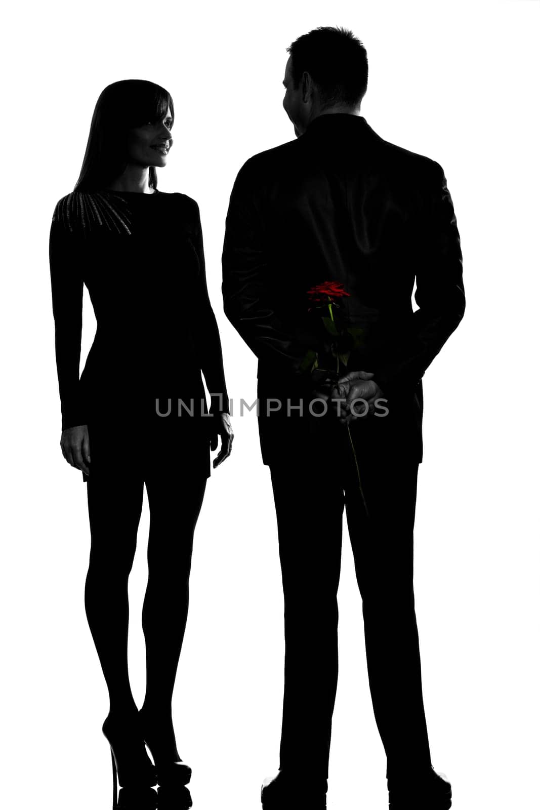 one caucasian couple man and woman smiling in studio silhouette isolated on white background