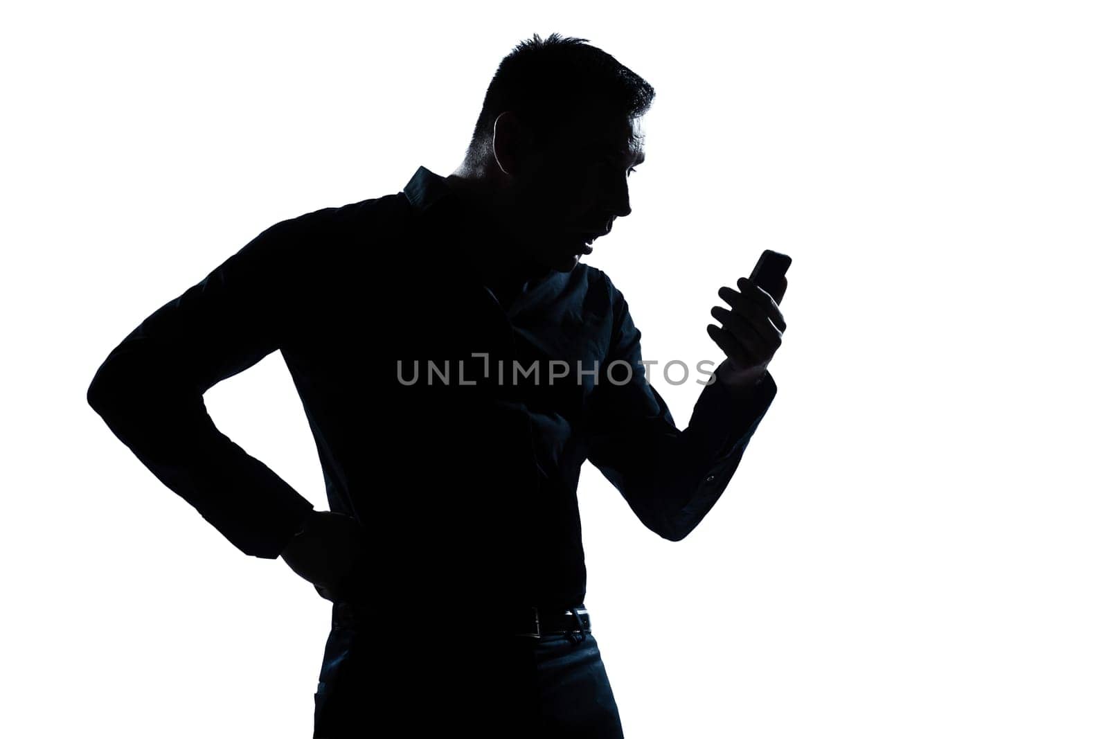 one caucasian man surprised telephone videophone  portrait silhouette in studio isolated white background