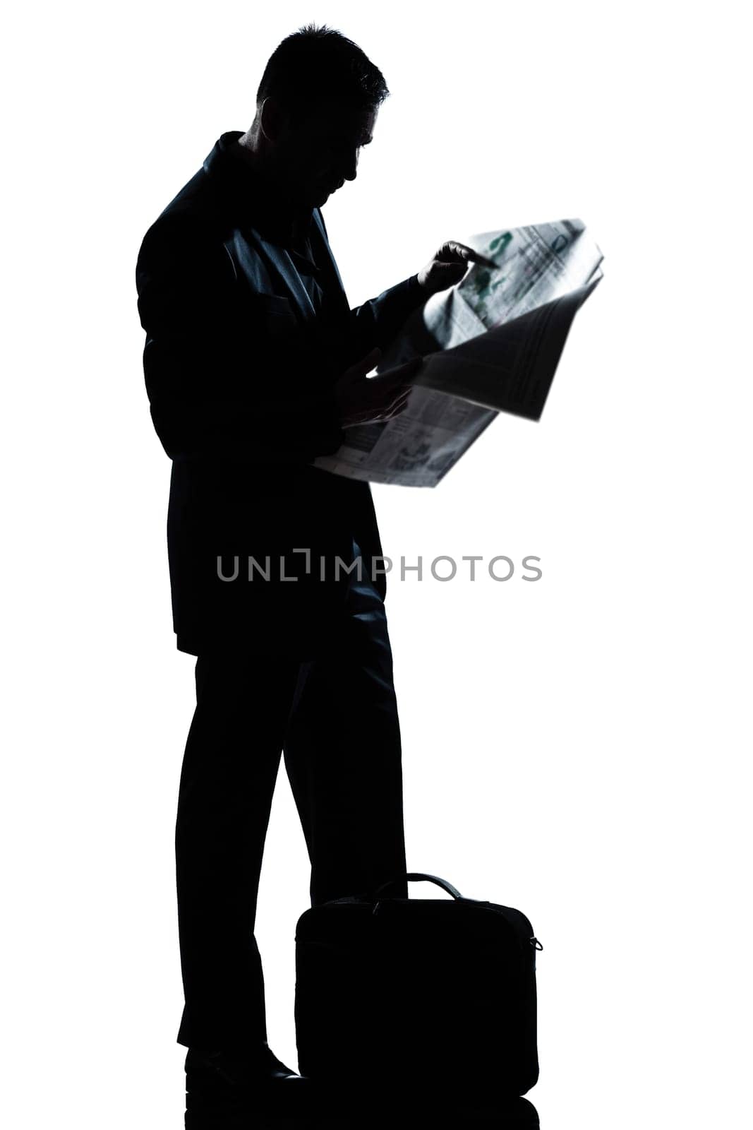 one caucasian man standing reading newspaper  full length silhouette in studio isolated white background