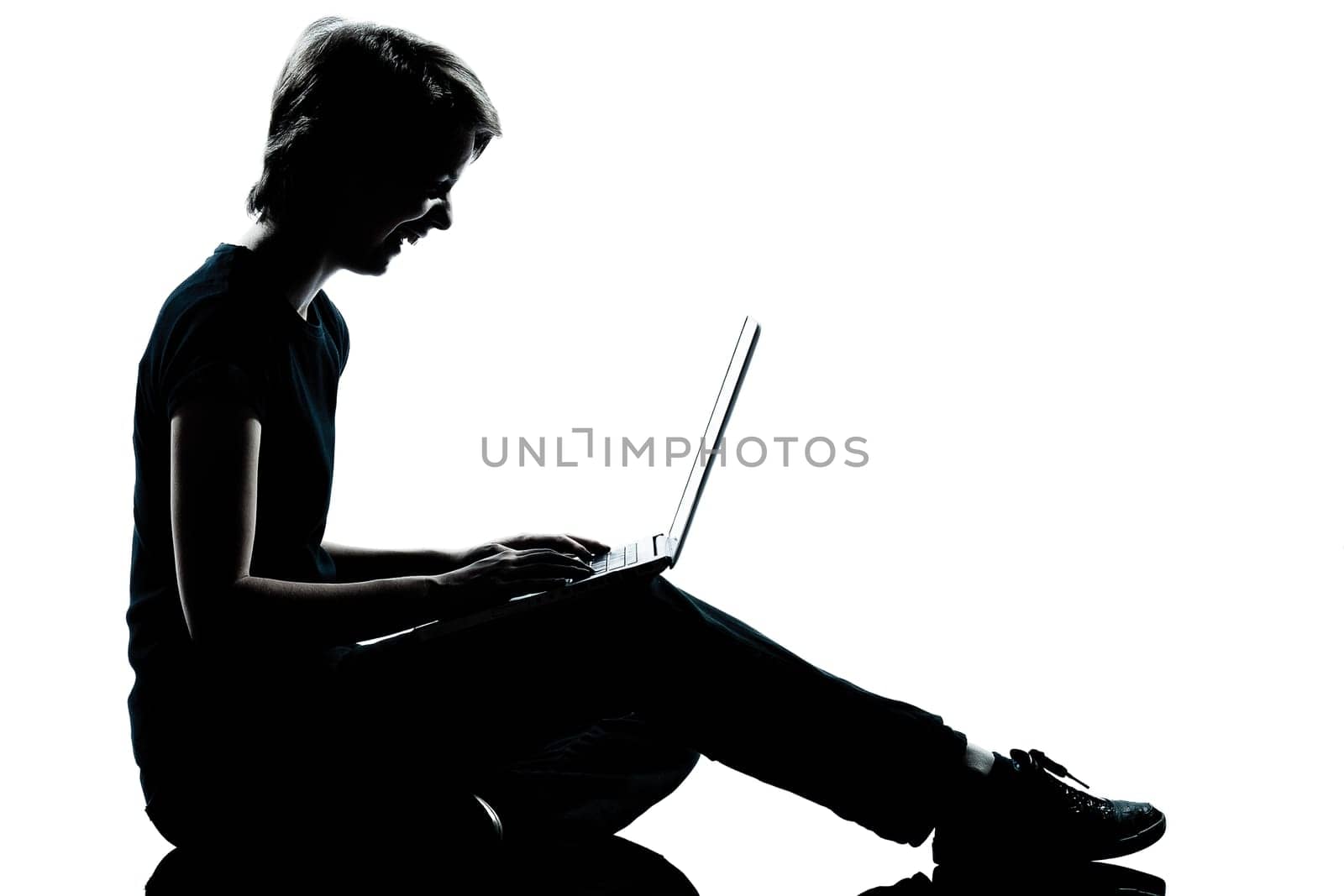 one caucasian young teenager silhouette boy girl computer computing laptop laughing full length in studio cut out isolated on white background