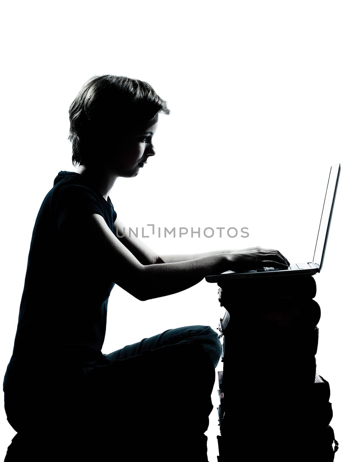 one caucasian young teenager silhouette boy or girl sitting computer computing laptop books full length in studio cut out isolated on white background