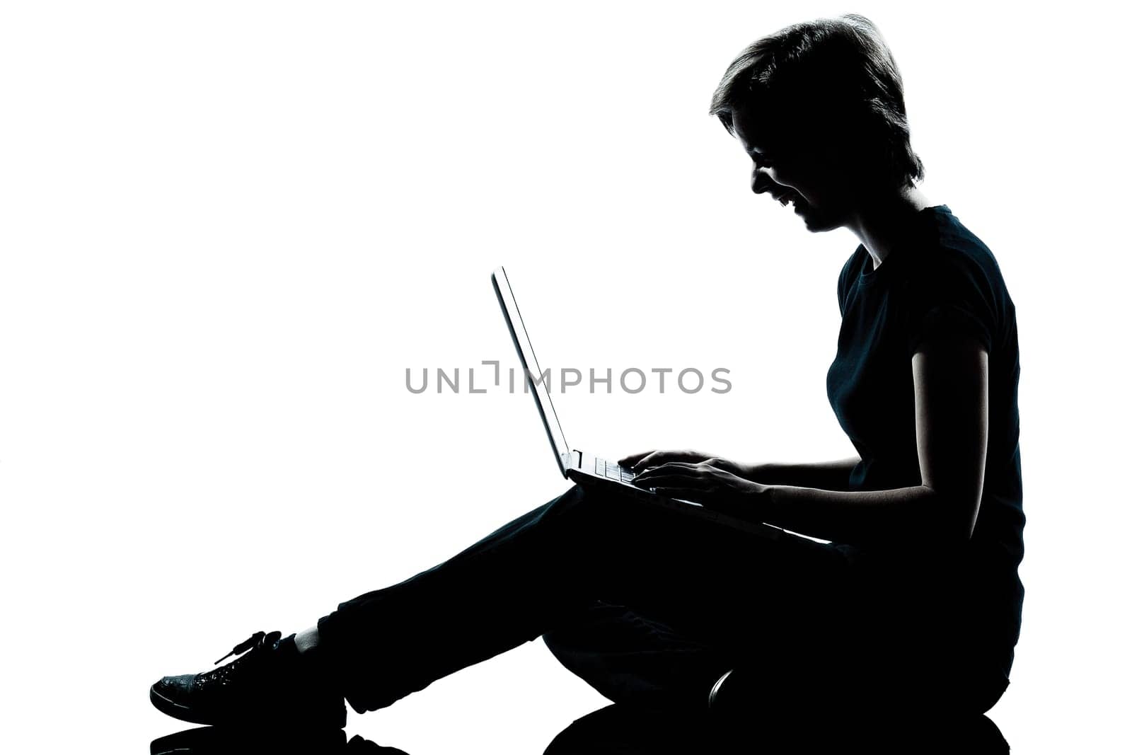 one caucasian young teenager silhouette  girl computer computing laptop laughing full length in studio cut out isolated on white background