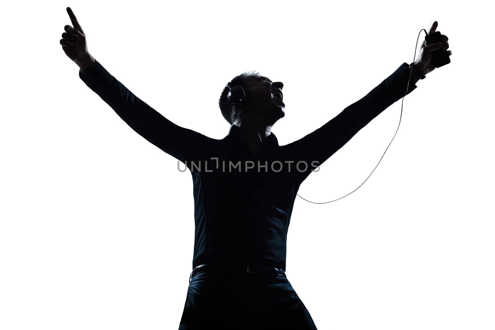 one caucasian man happy listening to music portrait silhouette in studio isolated white background