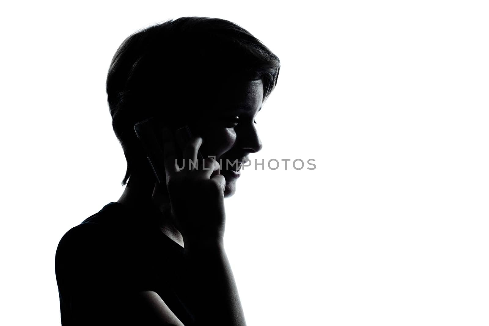 one caucasian young teenager silhouette boy or girl on the telephone  portrait in studio cut out isolated on white background