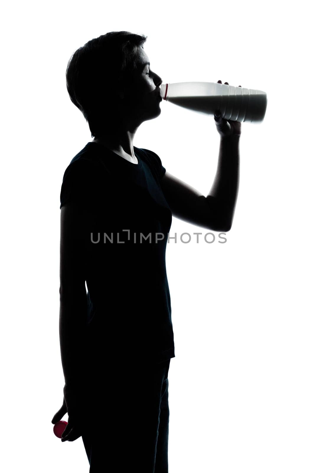 one caucasian young teenager silhouette boy or girl drinking milk  portrait in studio cut out isolated on white background