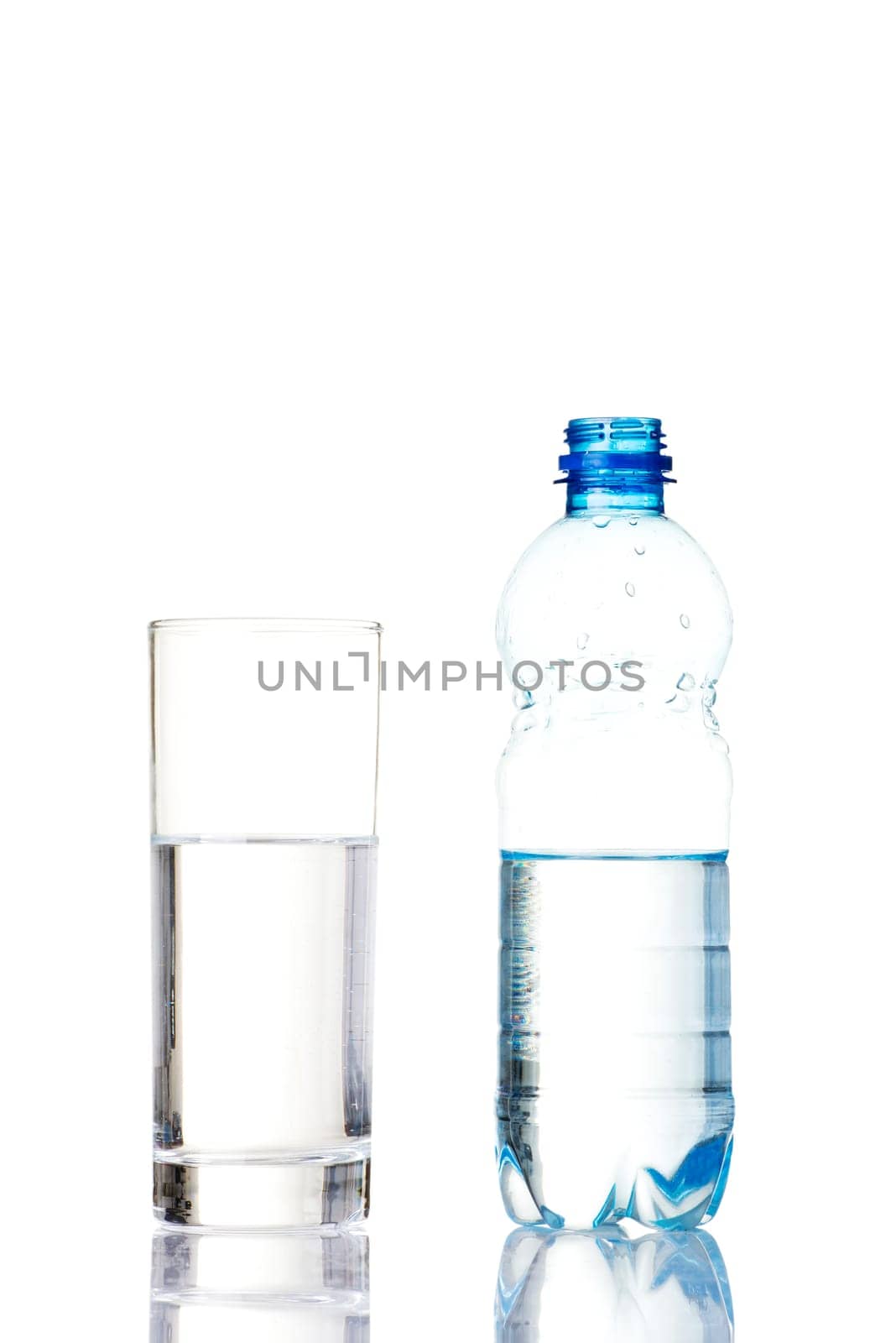 Bottle of water and glass. Isolated on white.
