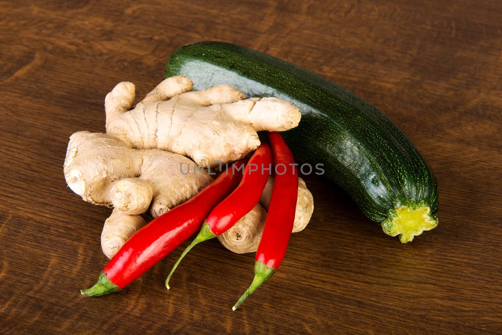 Zucchini, imbir and red hot chilie peppers on kitchen table
