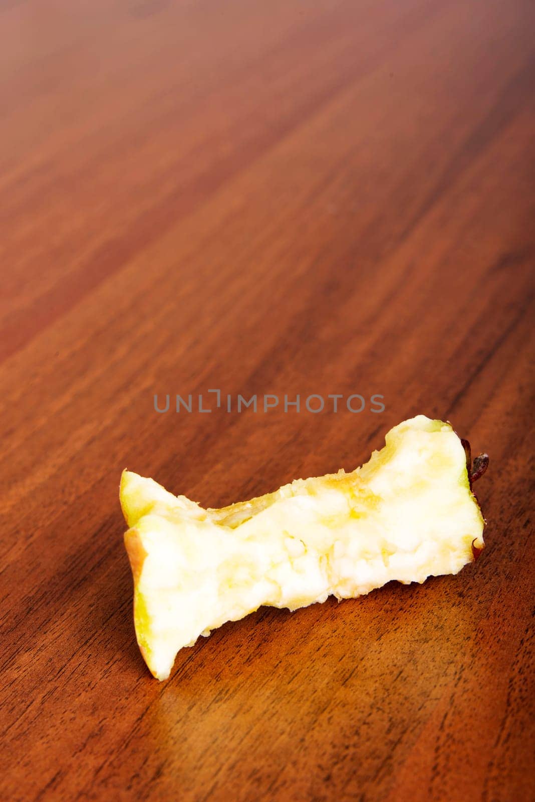 Bitten apple on the table or floor