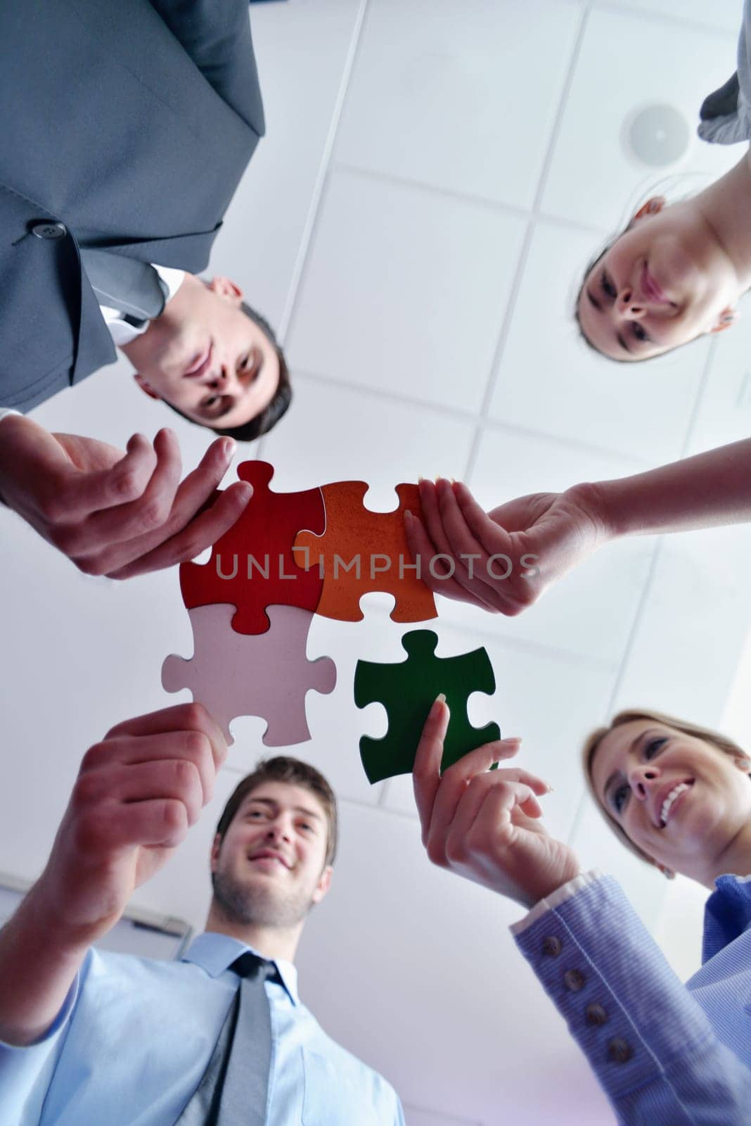 Group of business people assembling jigsaw puzzle and represent team support and help concept