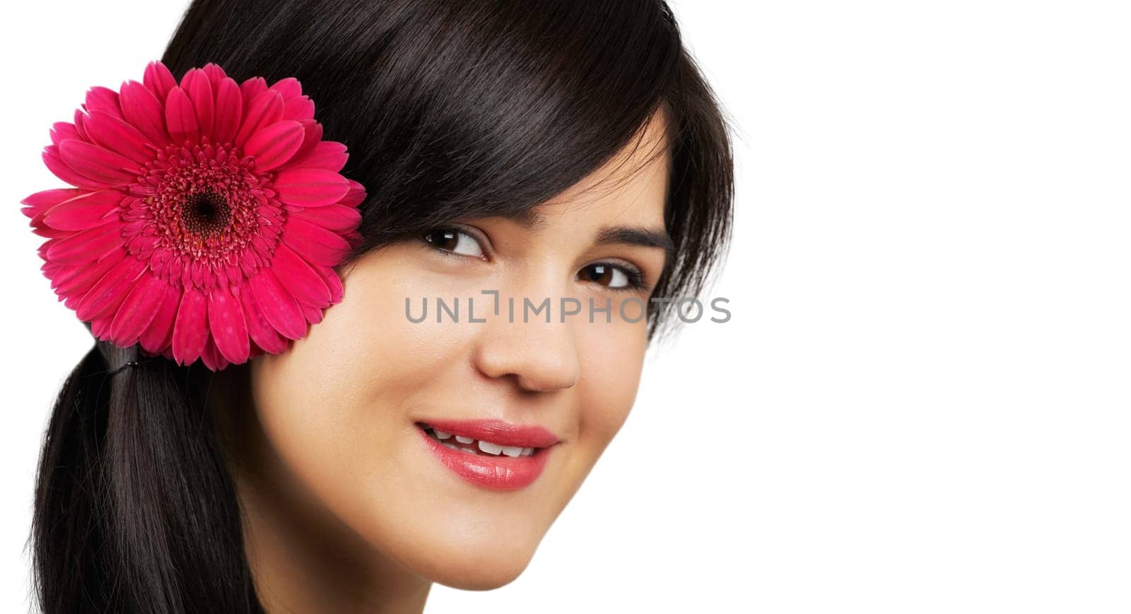 Portrait of a beautiful young woman with a flower on her ear isolated on white