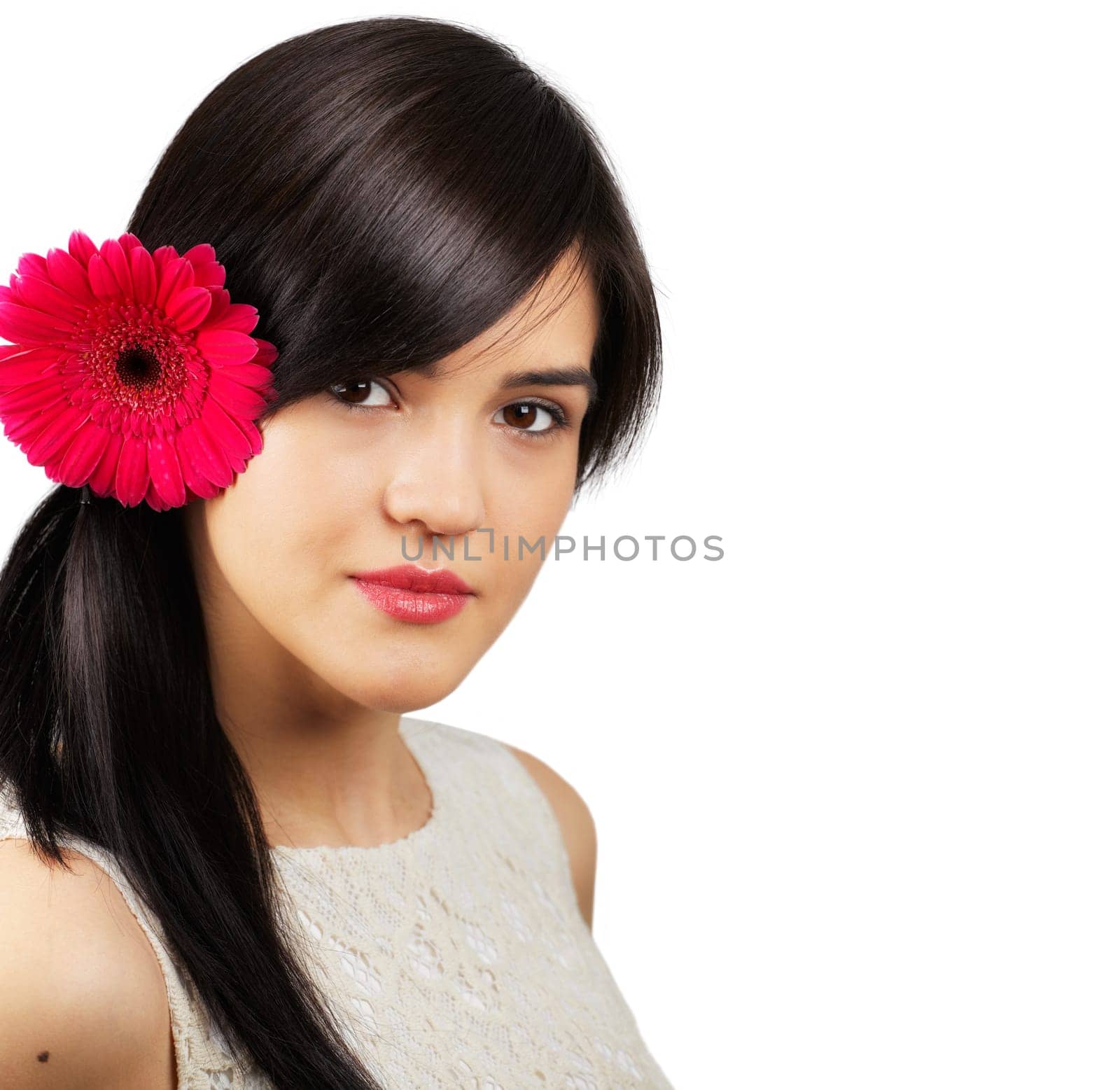 Portrait of a beautiful young woman with a flower on her ear isolated on white
