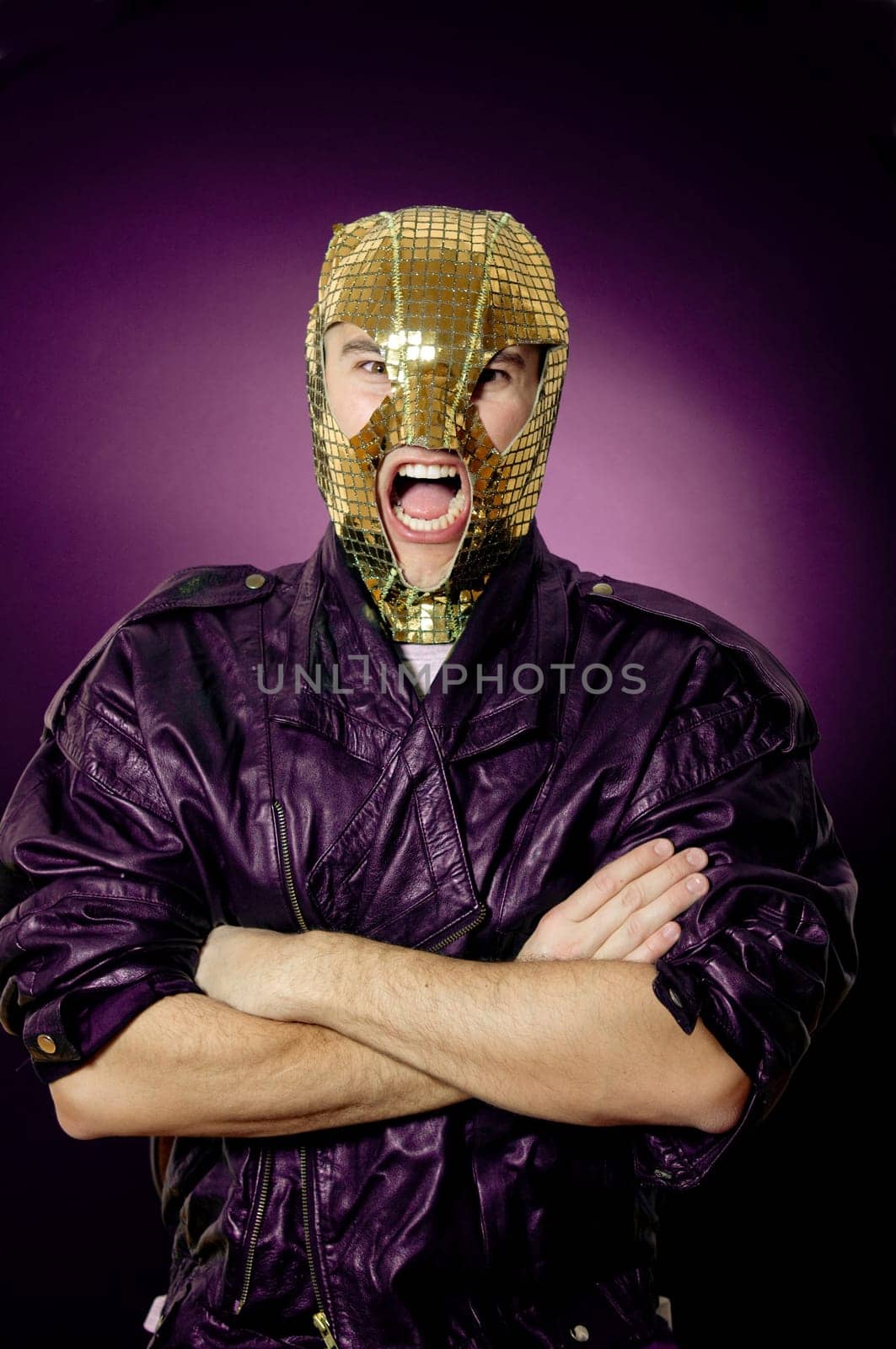 Man wearing gold mask and leather jacket