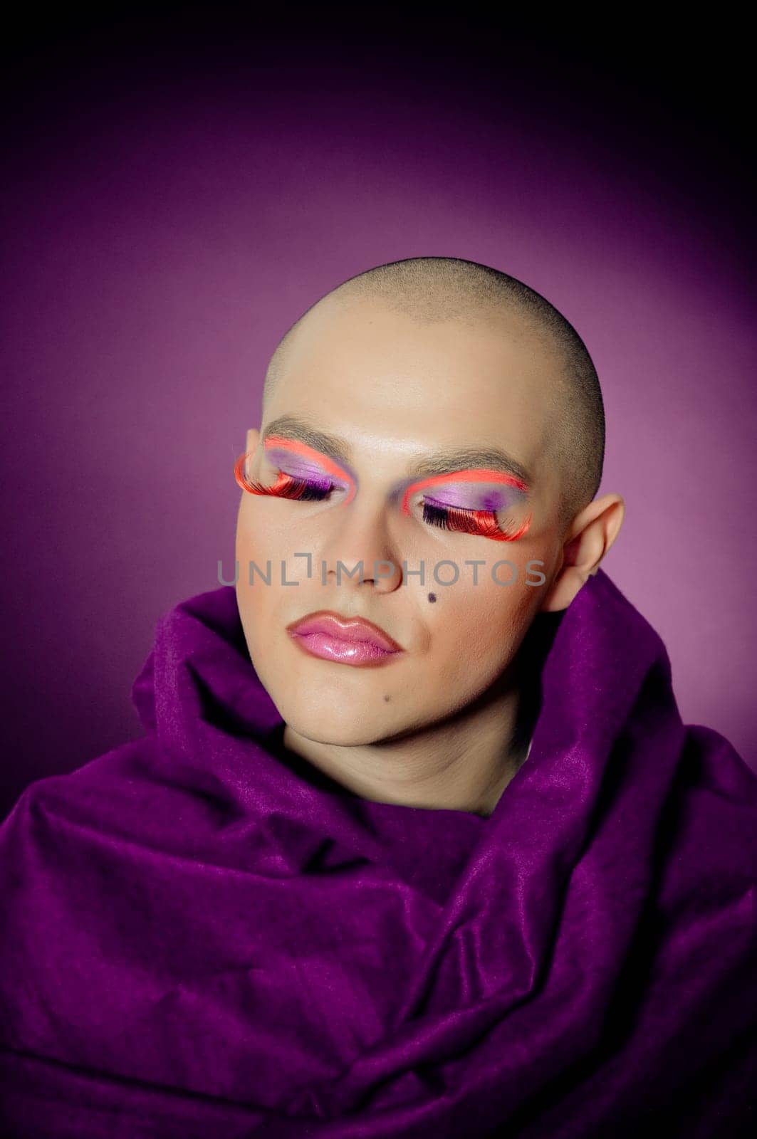 Handsom man with drag makeup on violet background