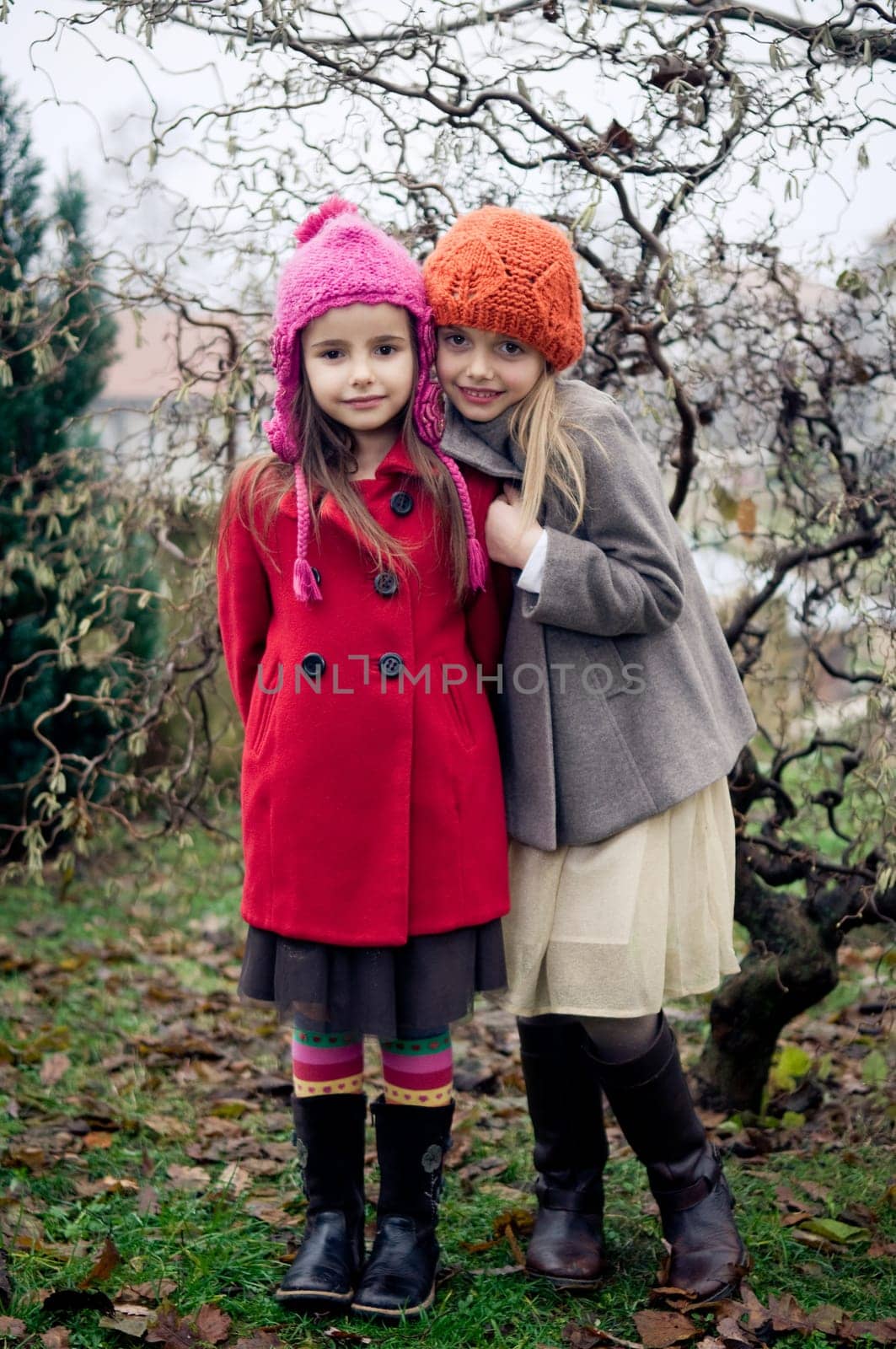 Two cute girls in vintage clothes posing