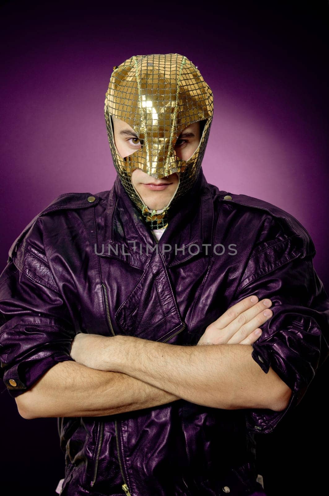 Man wearing gold mask and leather jacket