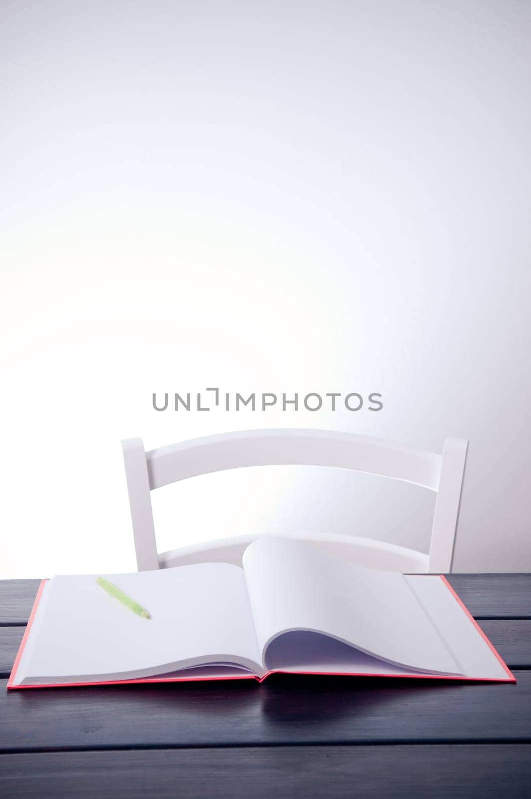 Empty chair and blank notebook on the table