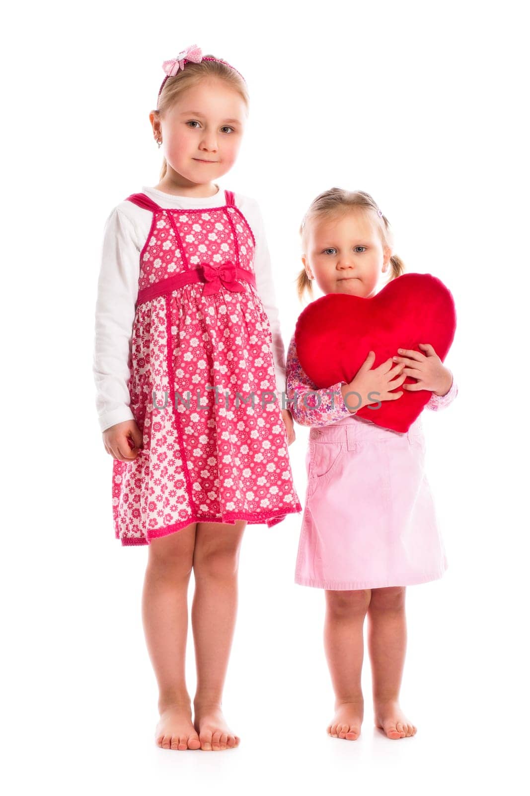 studio shot of two sisters with heart