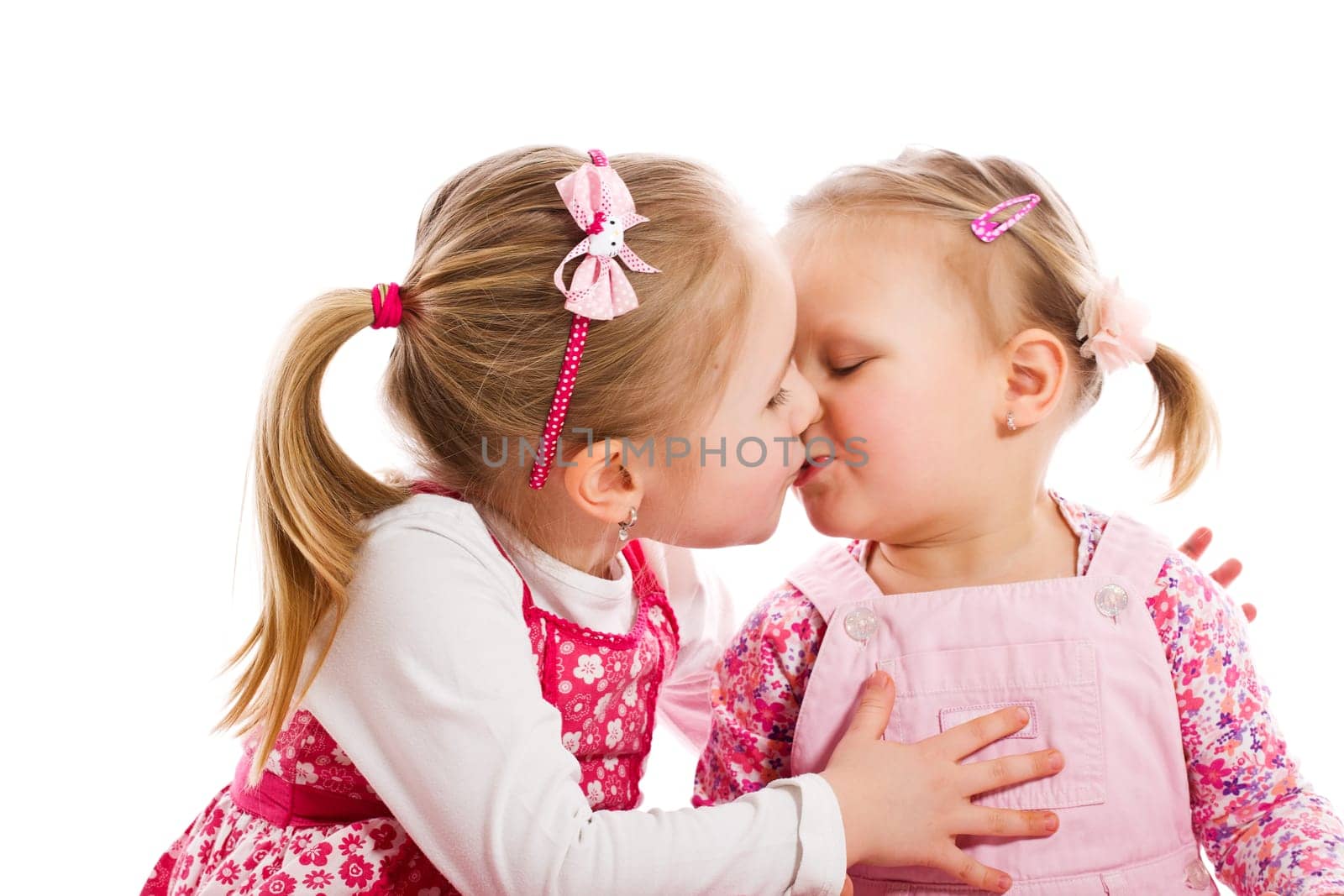 studio shot of two kissing child