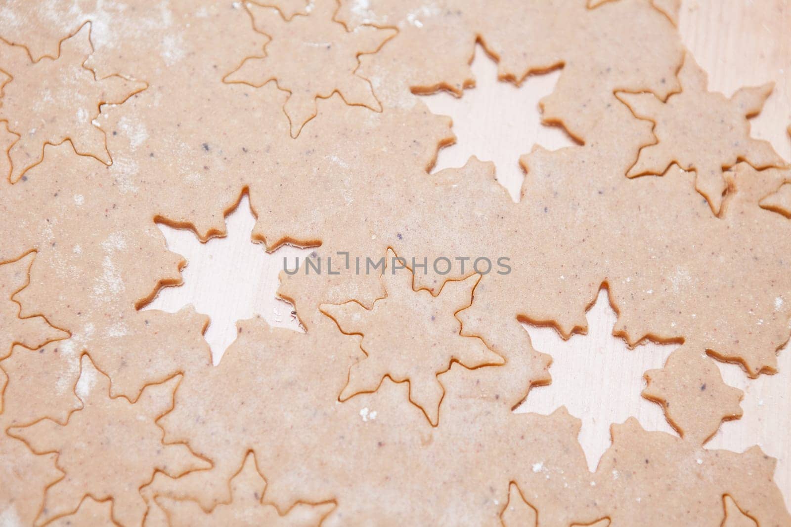 Closeup of gingerbread biscuit dough with star shapes