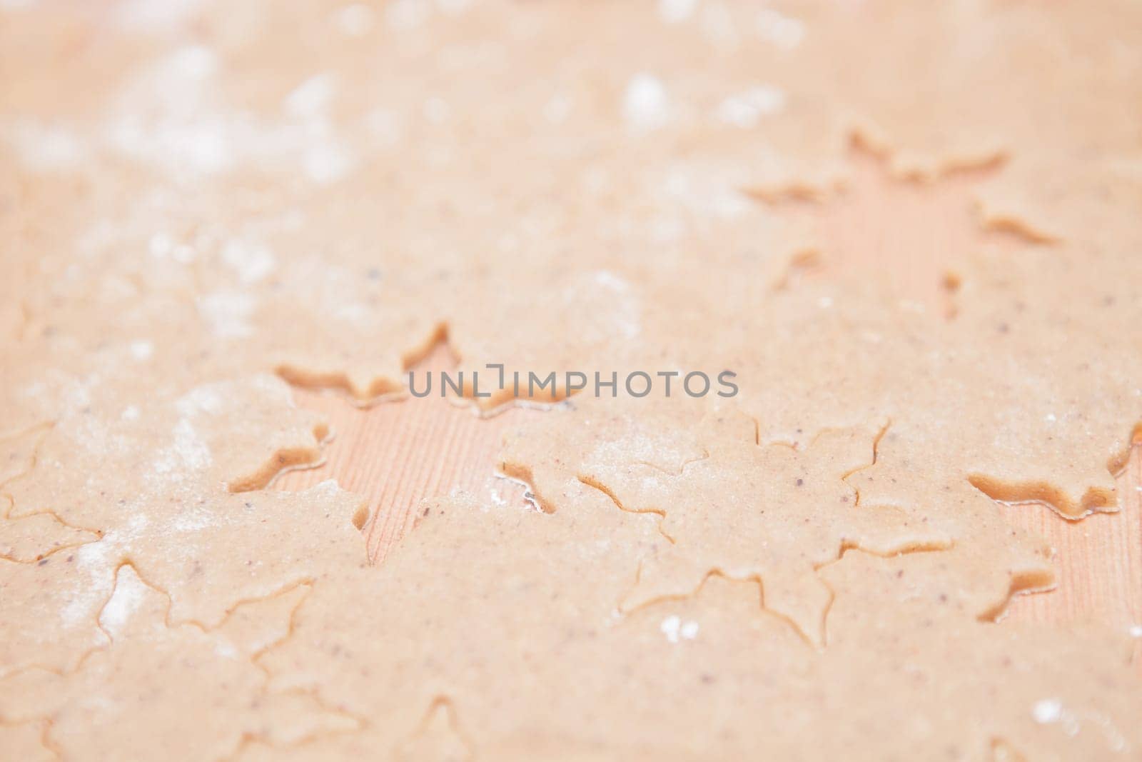 Closeup of gingerbread biscuit dough with star shapes
