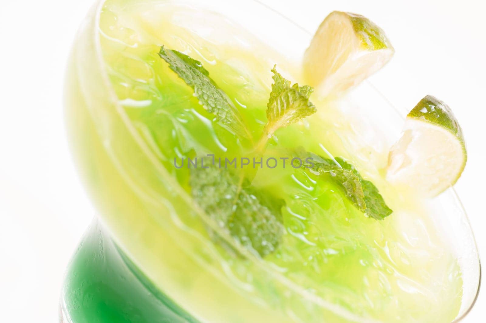 Citrus Paradise Cocktail made from Midori Melon, White Rum, pineapple, lime juice and garnishes with lime slice and fresh mints leaves