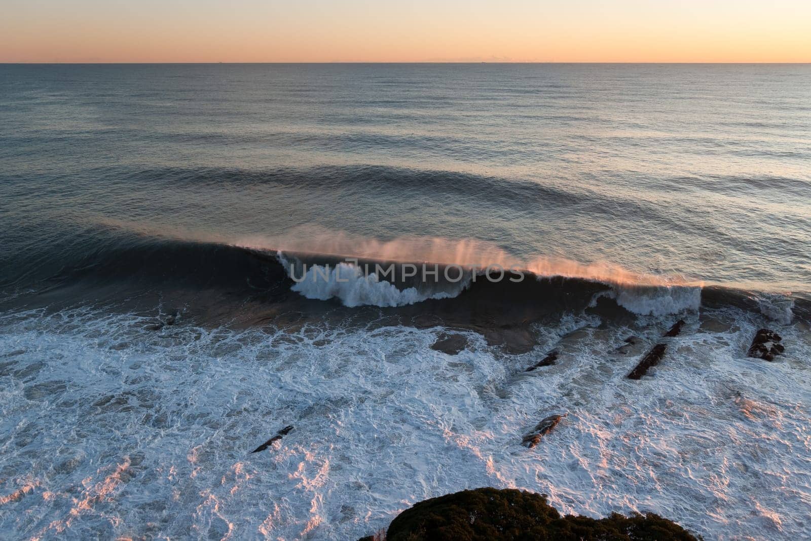 wave and wind at sunset in Genoa