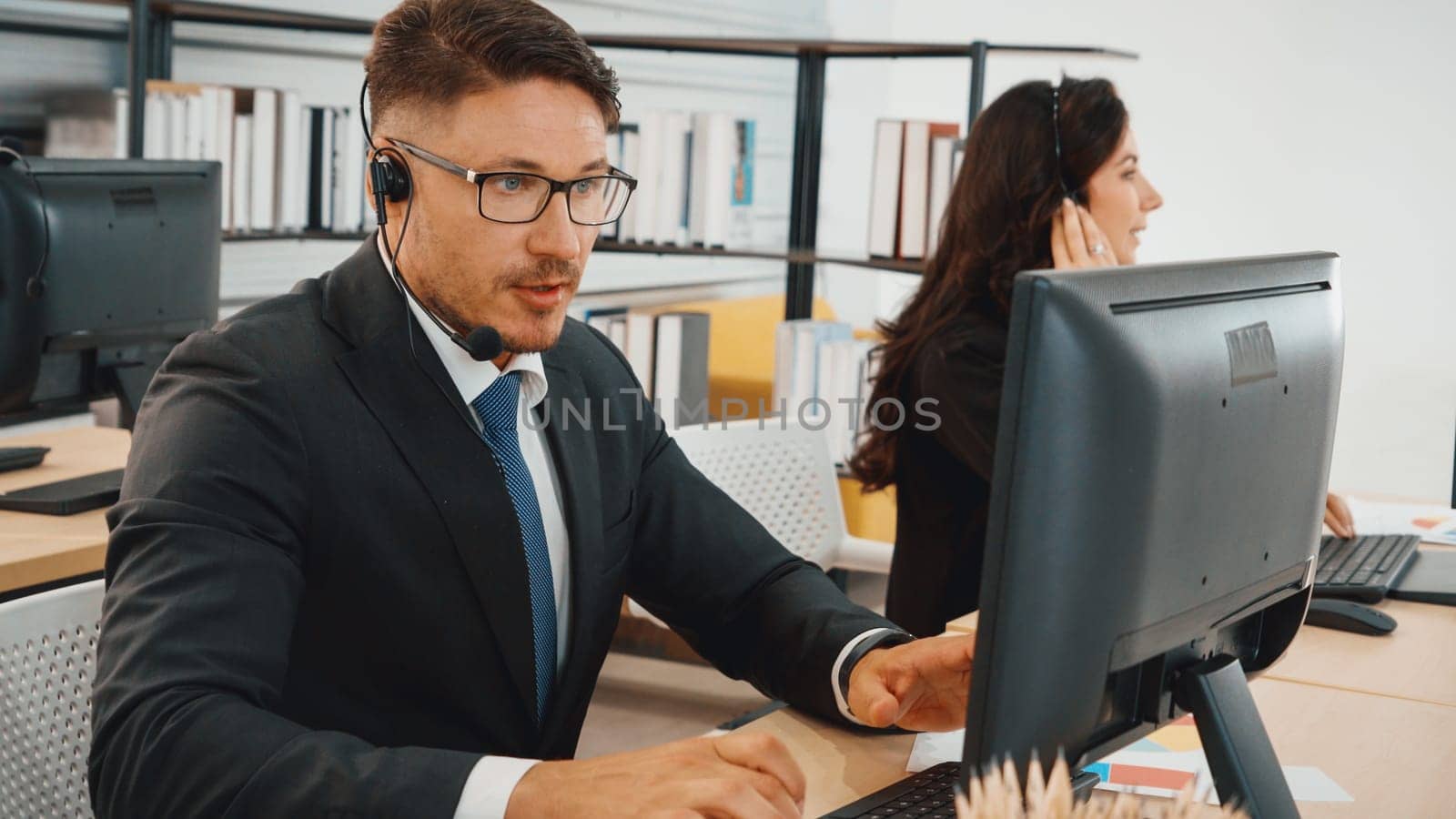 Business people wearing headset working in office Jivy by biancoblue