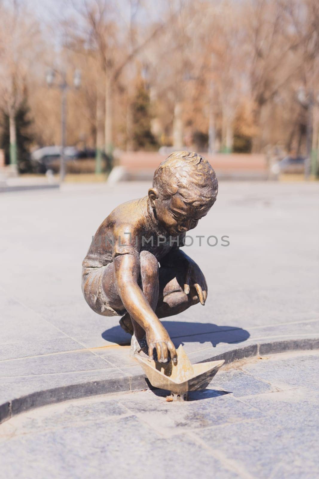 YEREVAN. ARMENIA. 29 MARCH 2022 : Bronze statue of a happy boy playing with a paper boat in the new Park dedicated to the 2800th anniversary of the Foundation of Yerevan by Satura86