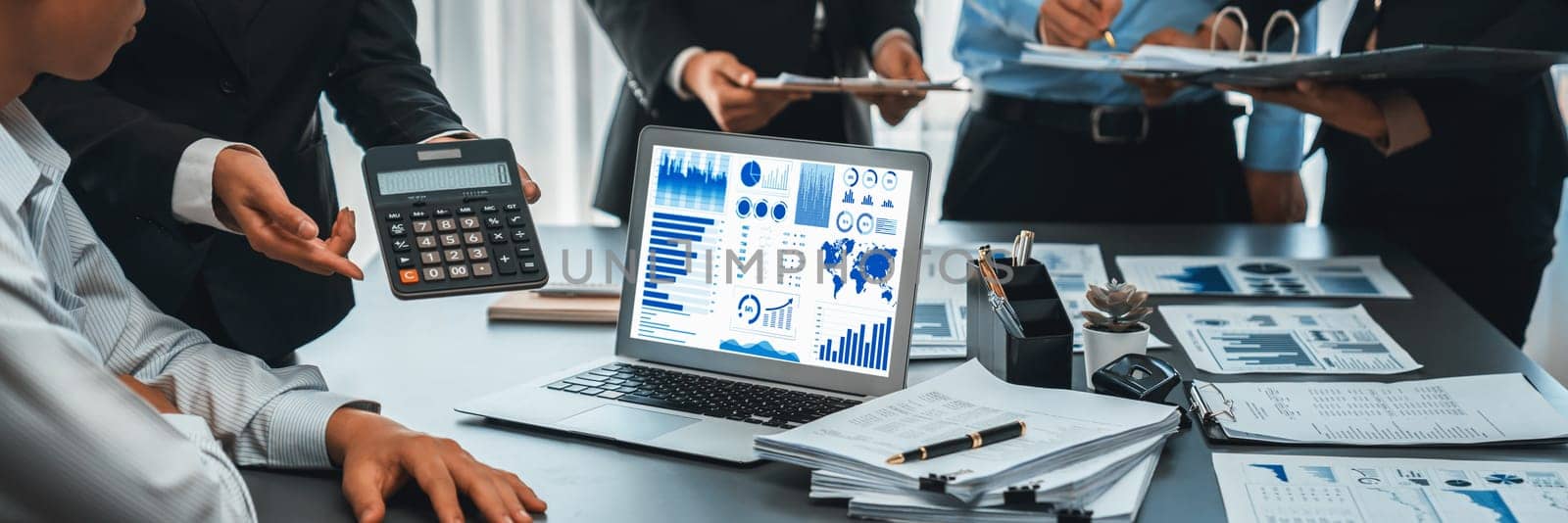 Business intelligence and data analysis concept. Analyst team working on financial data analysis dashboard on laptop screen as marketing indication for effective business strategic planning. Insight