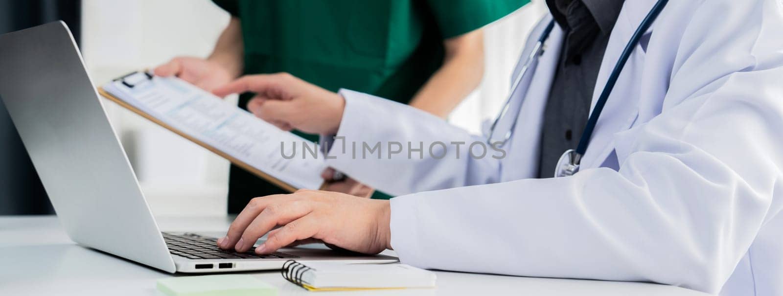 Professional various team of medical working and planning medical treatment at hospital table together. Teamwork lead to successful illness and sickness treatment. Panorama Rigid