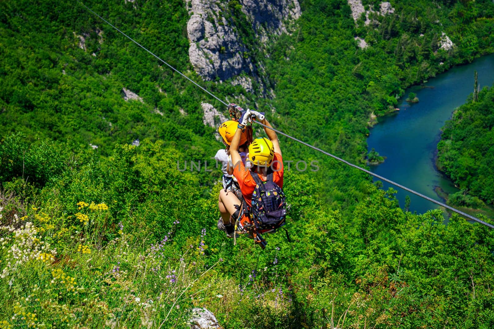 Women Enjoying a Thrilling Zipline Experience, Embracing the Exhilaration of Activity-filled Vacation and Stunning Tourism Views