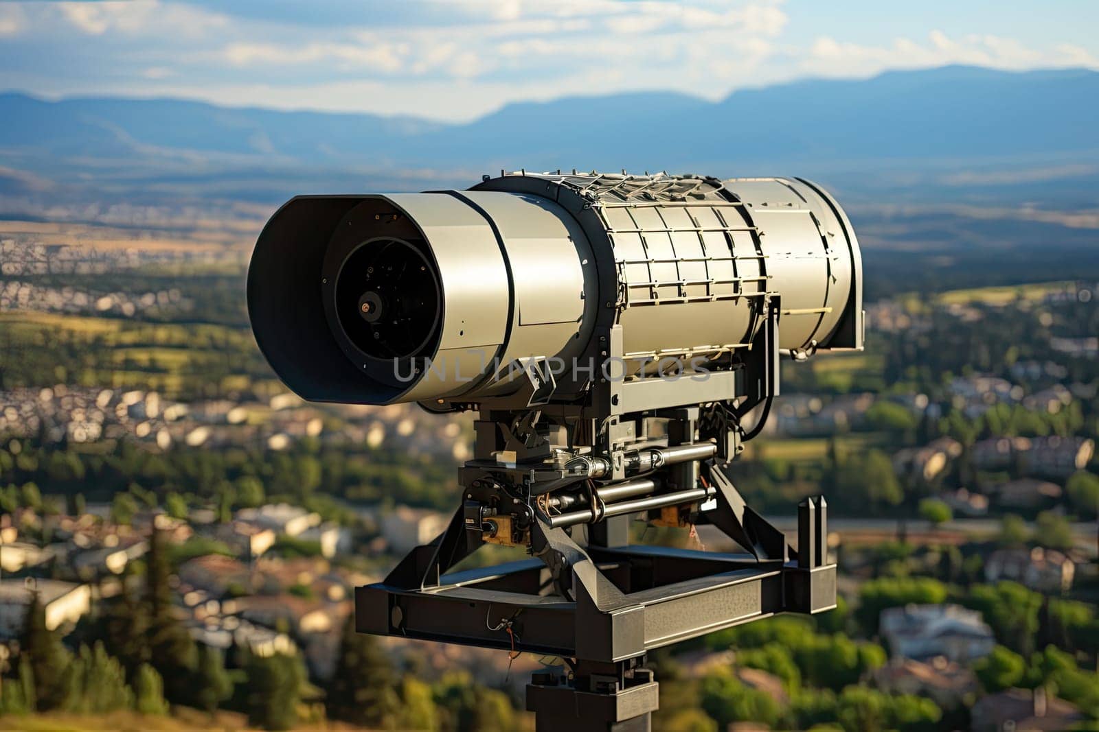 a telescope on top of a tripod with mountains in the distance and blue sky above it, as seen from an overlook point