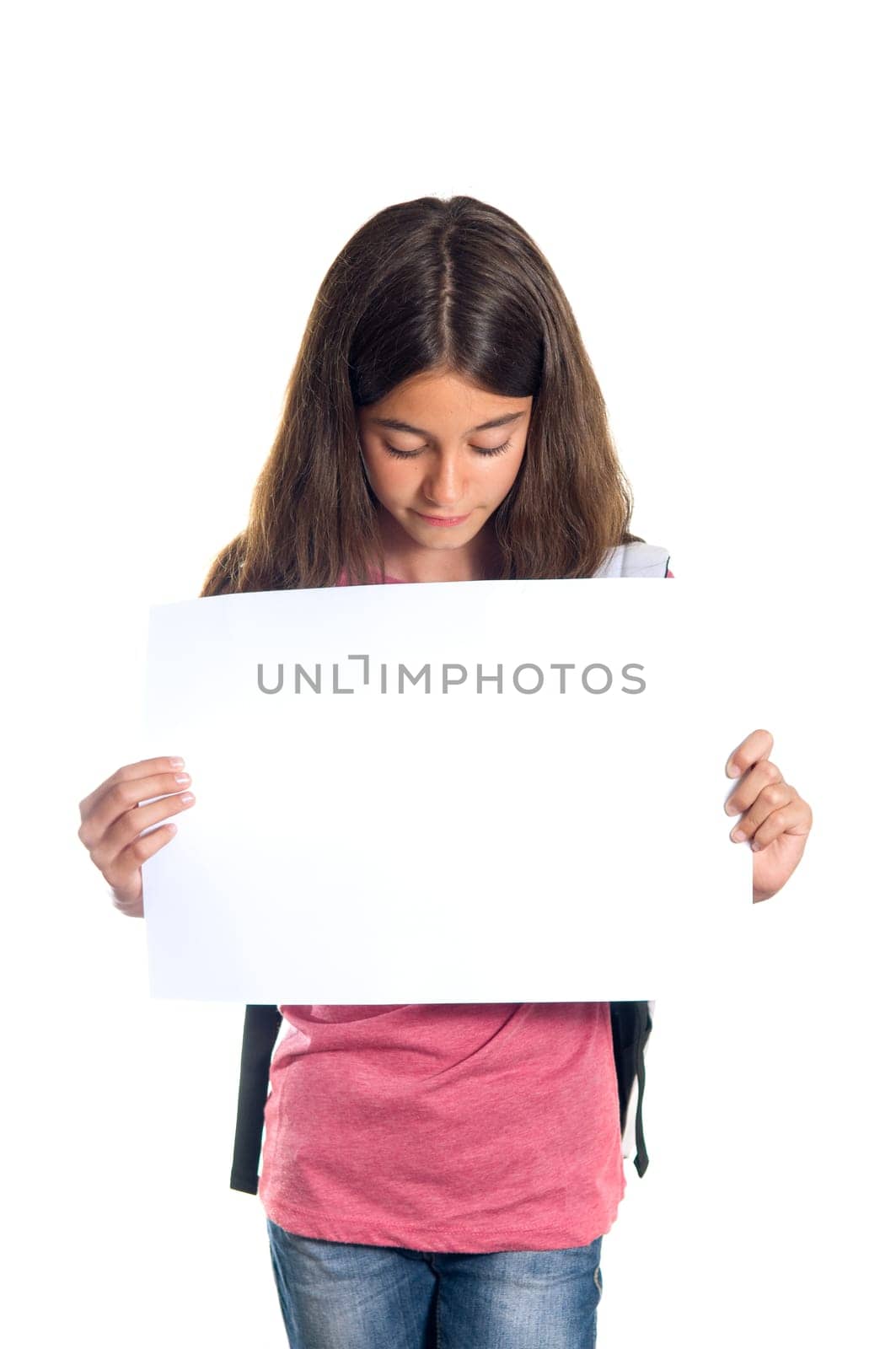 Schoolgirl with backpack holding a white sheet of paper