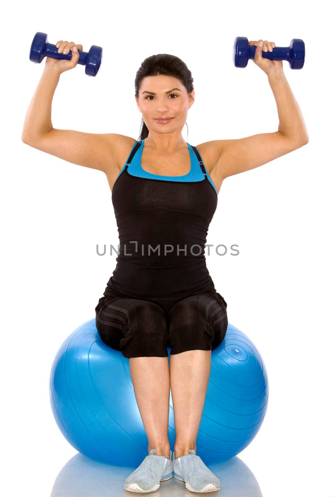 pretty brunette wearing sport outfit on white background