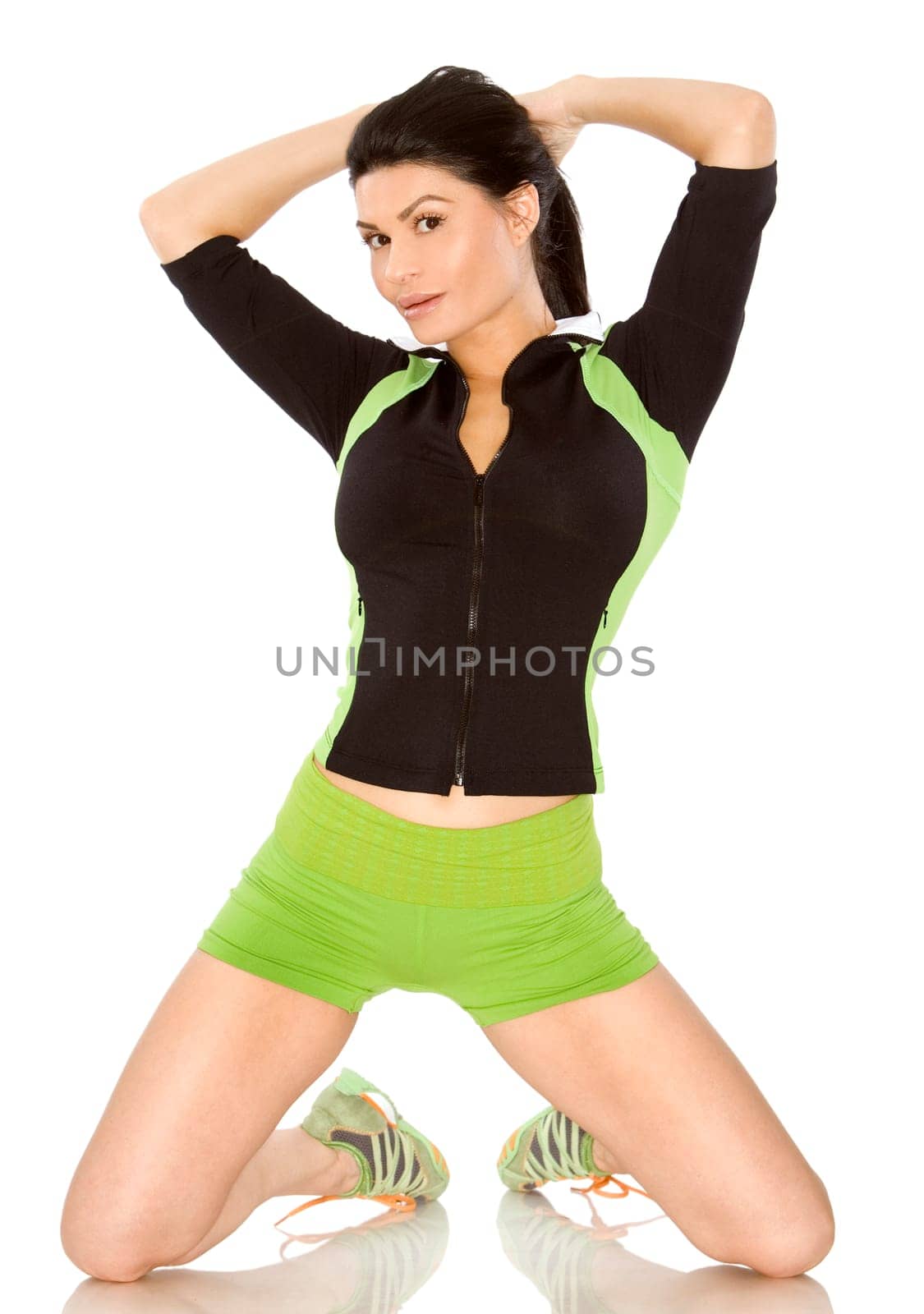pretty brunette wearing sport outfit on white background
