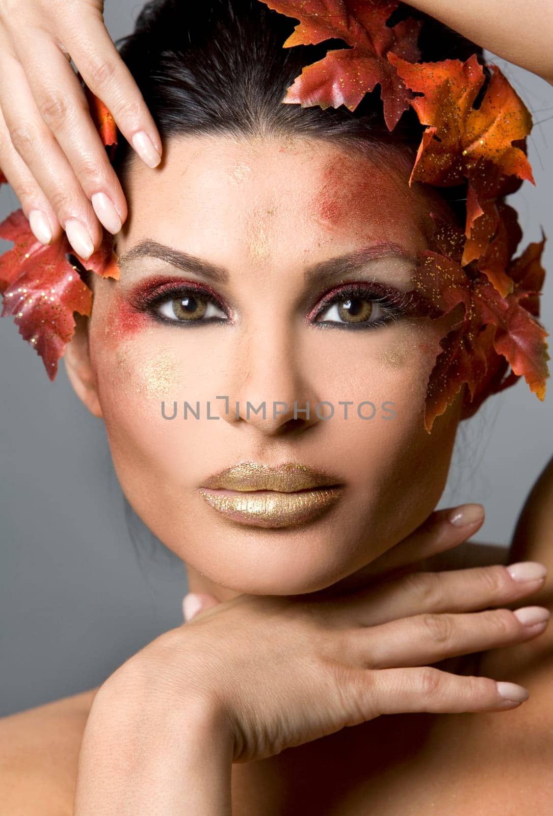 pretty brunette woman wearing leaves and colorful makeup