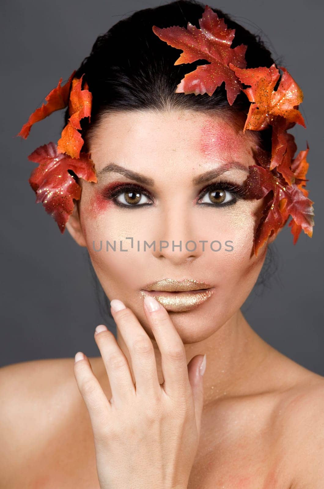 pretty brunette woman wearing leaves and colorful makeup