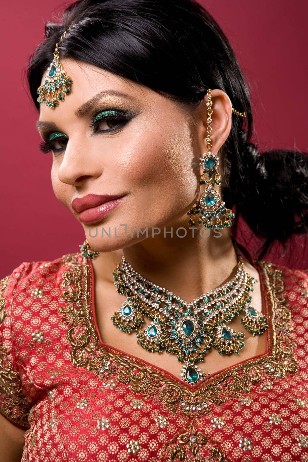 beautiful indian woman wearing bridal outfit on red