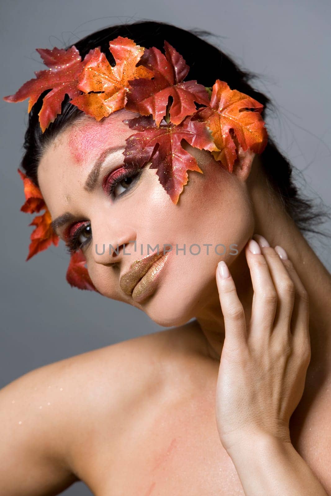pretty brunette woman wearing leaves and colorful makeup