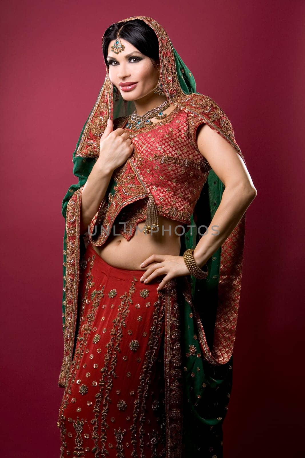 beautiful indian woman wearing bridal outfit on red