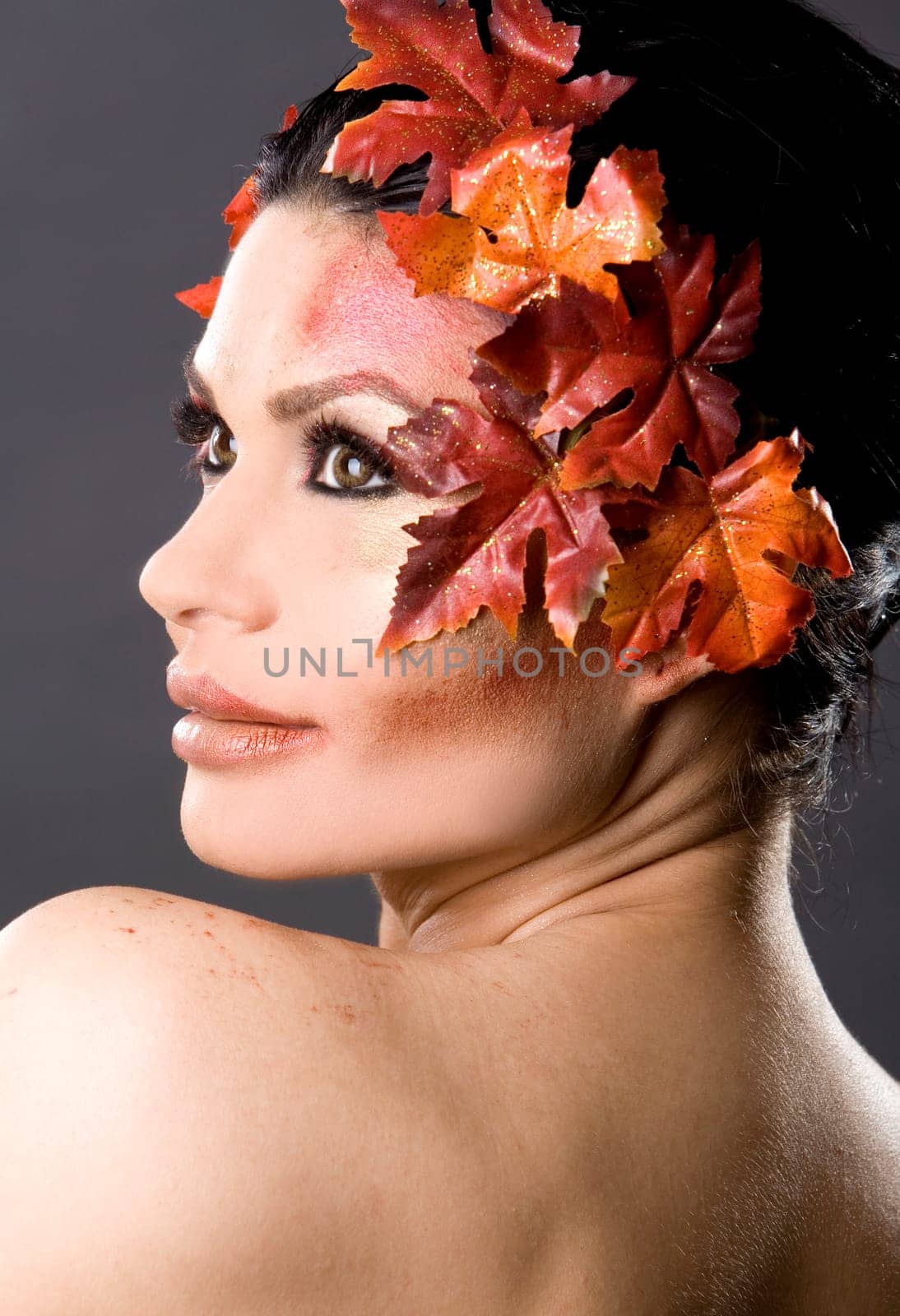 pretty brunette woman wearing leaves and colorful makeup
