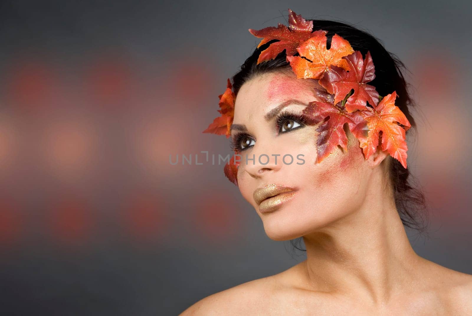 pretty brunette woman wearing leaves and colorful makeup