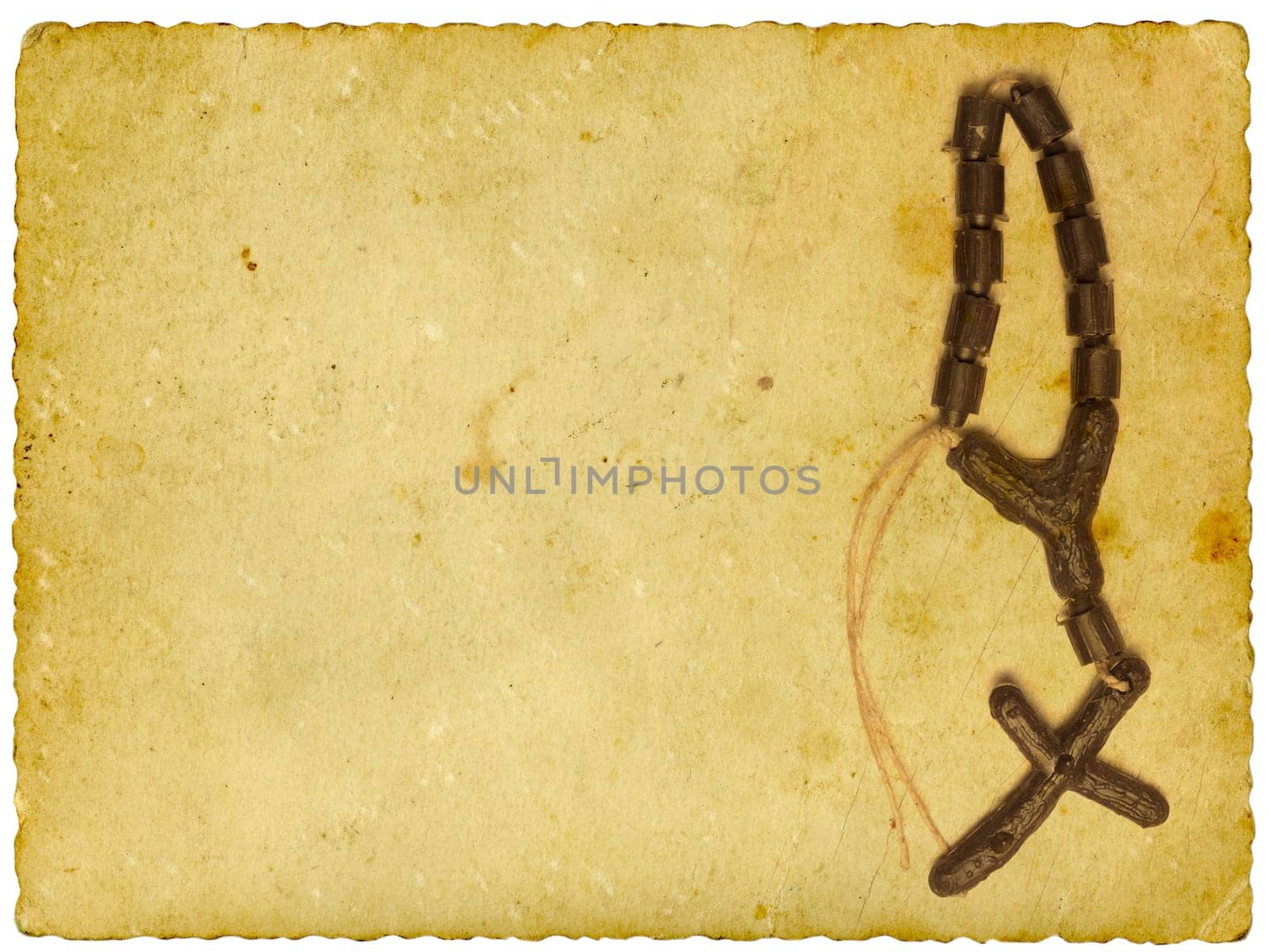 Rosary on vintage background. Isolated on white.